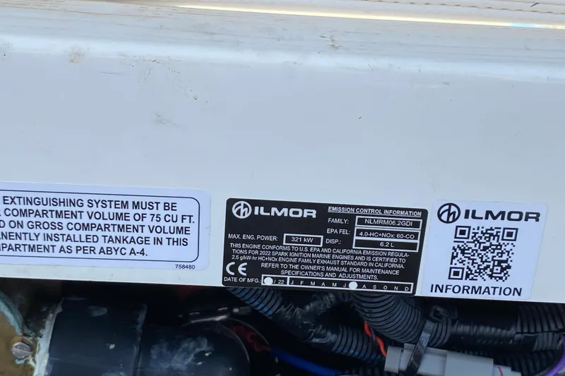 Slide: The Image of 2022 MasterCraft XT25 engine label with Ilmor emission control information and QR code. - 14