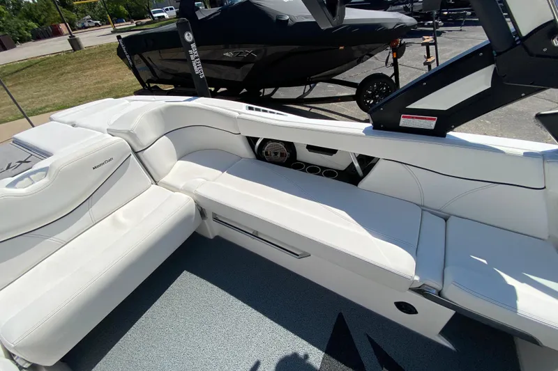 Slide: The Image of 2022 MasterCraft XT25 boat interior with white seating and modern design. - 17