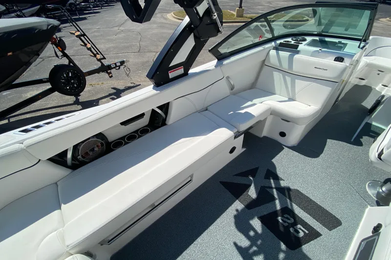 Slide: The Image of 2022 MasterCraft XT25 boat interior with white seating and modern design. - 18