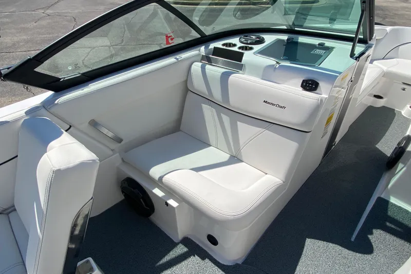 Slide: The Image of 2022 MasterCraft XT25 boat interior with white seating and dashboard. - 20