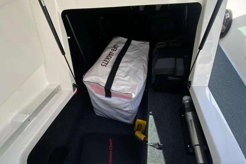 Slide: The Image of Storage compartment in 2022 MasterCraft XT25 boat with life jackets. - 21