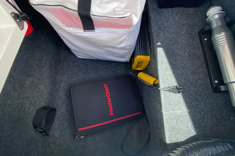 Slide: The Image of Storage compartment of 2022 MasterCraft XT25 with accessories and equipment. - 22