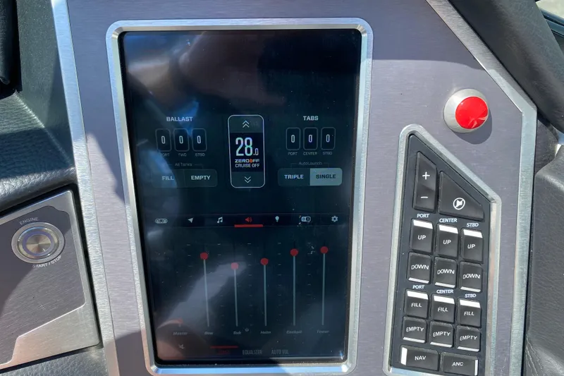 Slide: The Image of 2022 MasterCraft XT25 boat control panel with digital display and buttons. - 27