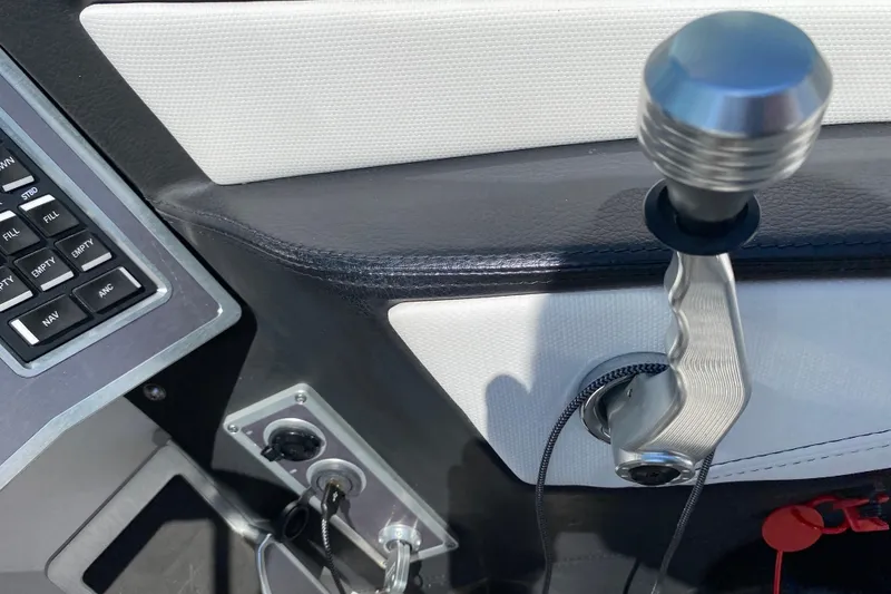 Slide: The Image of Control panel and throttle of 2022 MasterCraft XT25 boat interior. - 28