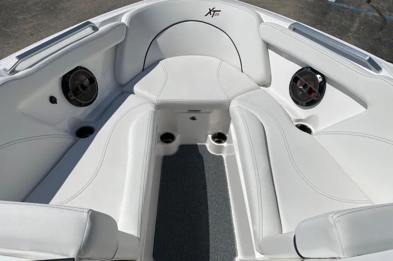 Slide: The Image of 2022 MasterCraft XT25 boat interior with white seating and built-in speakers. - 31