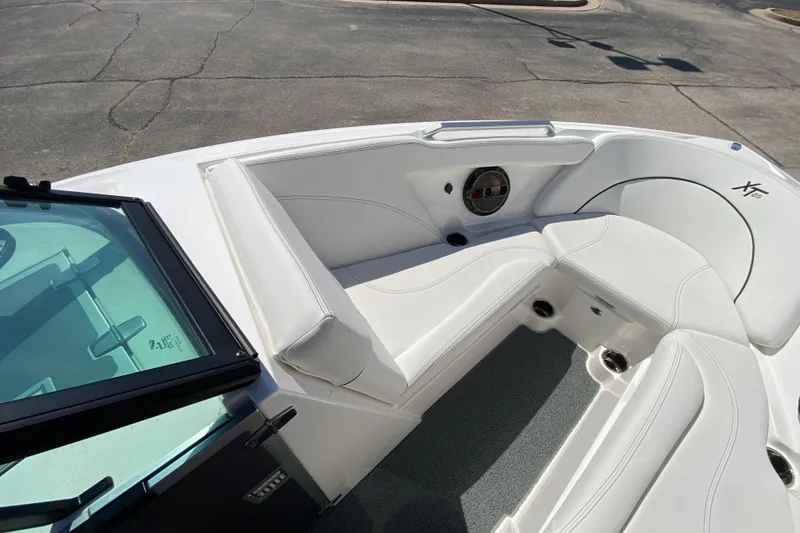 Slide: The Image of 2022 MasterCraft XT25 boat interior with white seating and speaker. - 33