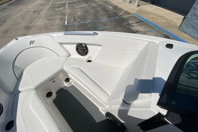 Slide: The Image of 2022 MasterCraft XT25 boat interior with white seating and speaker detail. - 34