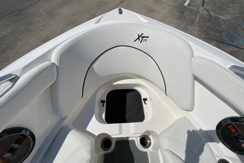 Slide: The Image of 2022 MasterCraft XT25 boat interior with white seating and speaker system. - 35