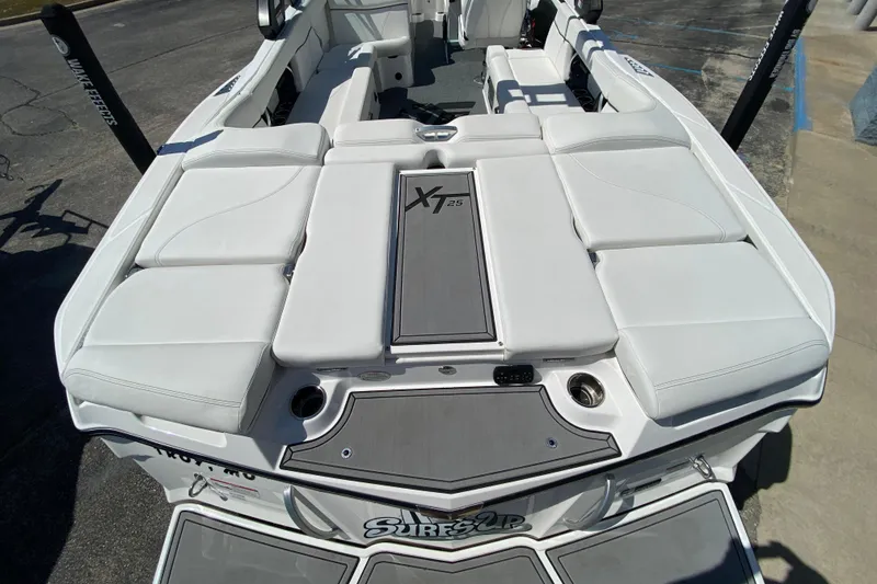 Slide: The Image of 2022 MasterCraft XT25 boat with white seating and sleek design. - 7