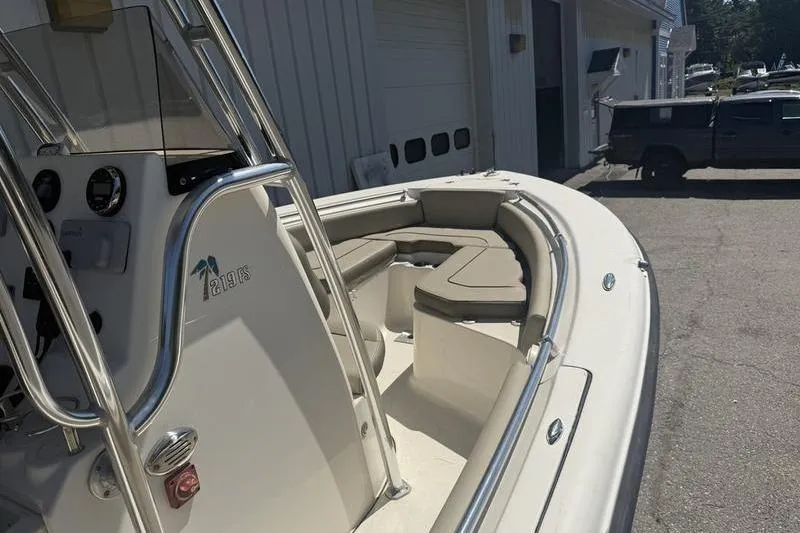 Slide: The Image of 2021 Key West 219 FS boat with seating, parked near a building. - 11