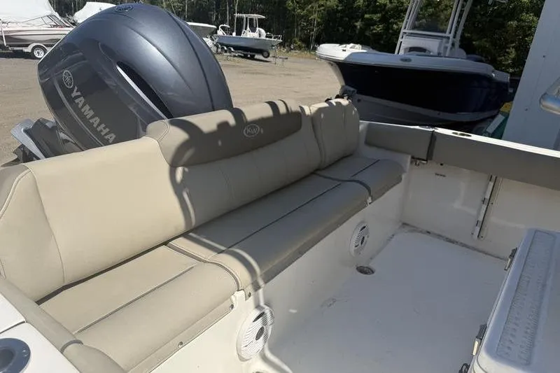 Slide: The Image of 2021 Key West 219 FS boat interior with Yamaha engine, featuring beige seating. - 3