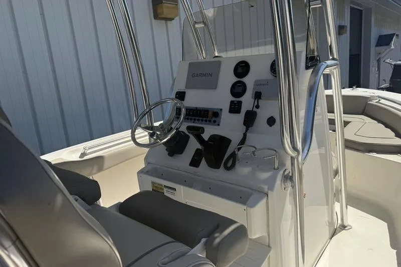 Slide: The Image of 2021 Key West 219 FS boat console with Garmin navigation system and seating. - 4