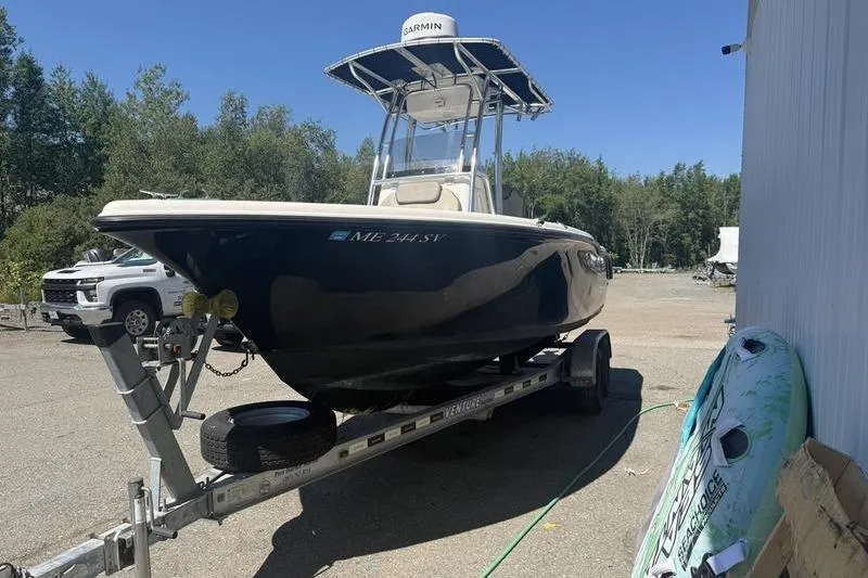 Slide: The Image of 2021 Key West 219 FS boat on trailer, parked outdoors near trees. - 7