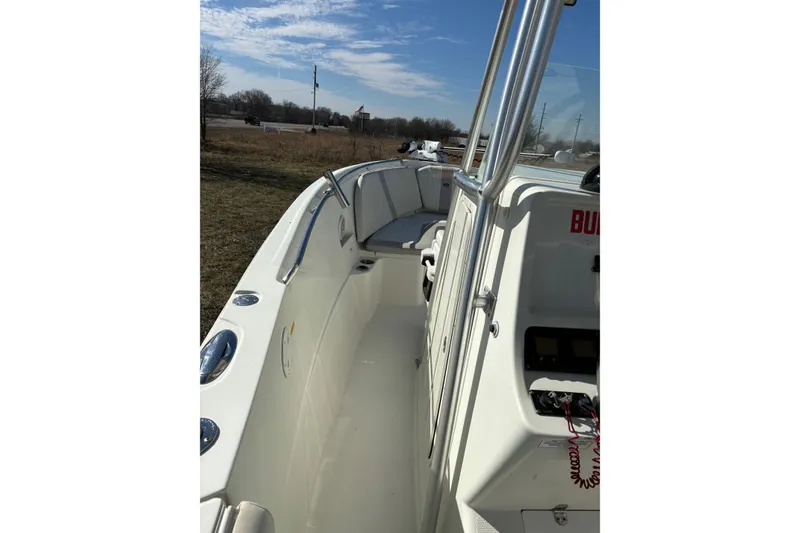 Slide: The Image of 2006 Sailfish 2660 CC boat interior with console and seating under clear sky. - 10
