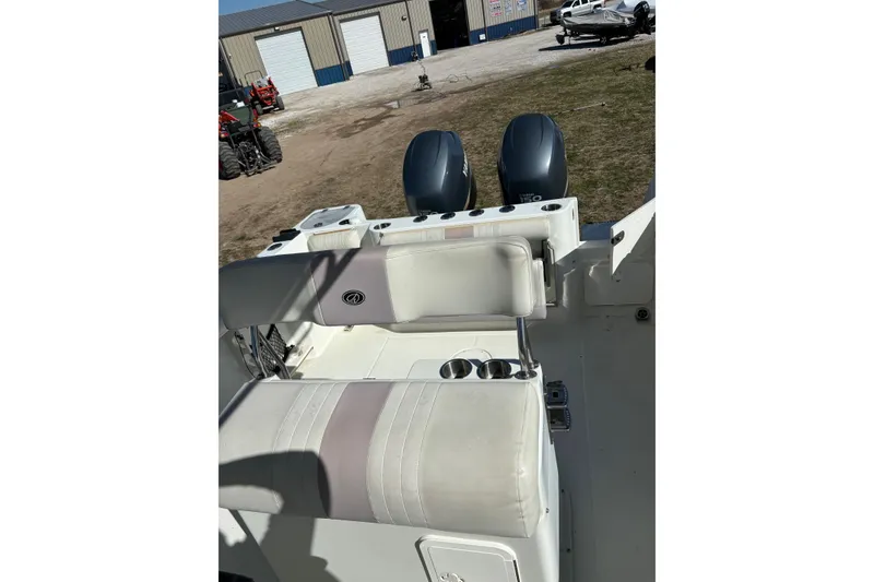 Slide: The Image of 2006 Sailfish 2660 CC boat interior with dual engines and cushioned seating. - 14