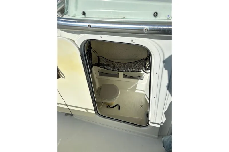 Slide: The Image of 2006 Sailfish 2660 CC boat interior with open hatch and visible storage area. - 15