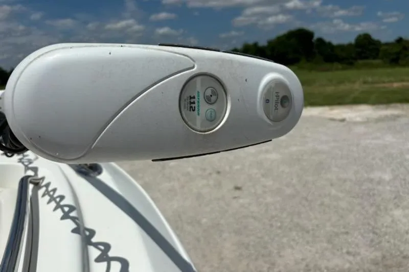 Slide: The Image of 2006 Sailfish 2660 CC boat with T-top and Pelican cooler, parked outdoors. - 7