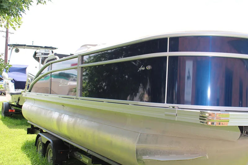 Slide: The Image of 2024 Barletta Aria 24UC pontoon boat on trailer, side view. - 2