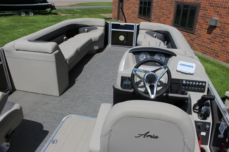 Slide: The Image of 2024 Barletta Aria 24UC pontoon boat interior with plush seating and modern dashboard. - 3