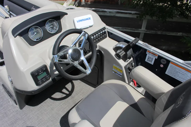 Slide: The Image of 2024 Barletta Aria 24UC boat dashboard with steering wheel and control panel. - 4