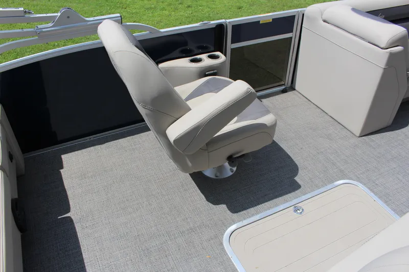Slide: The Image of 2024 Barletta Aria 24UC boat interior with swivel captain's chair and cup holders. - 5