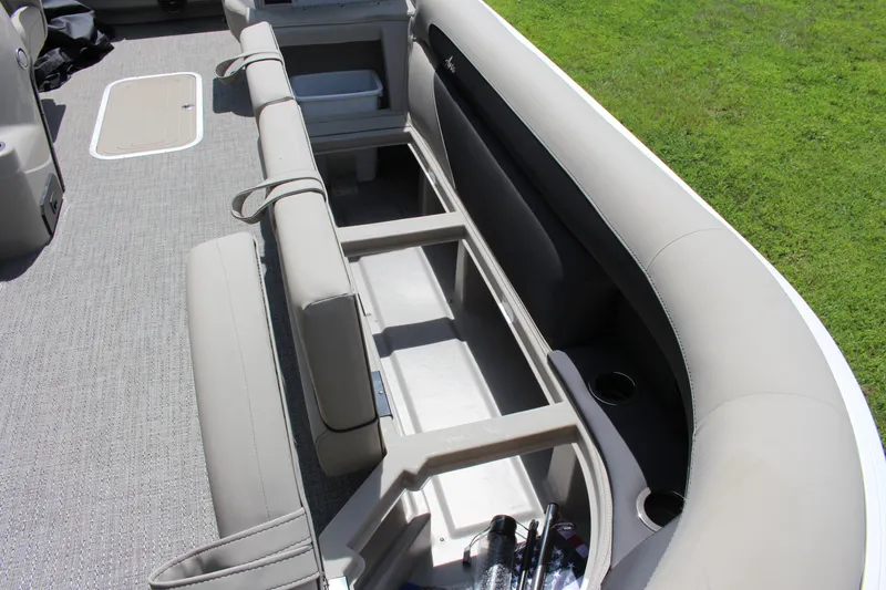 Slide: The Image of 2024 Barletta Aria 24UC boat interior with open storage compartment and seating. - 7