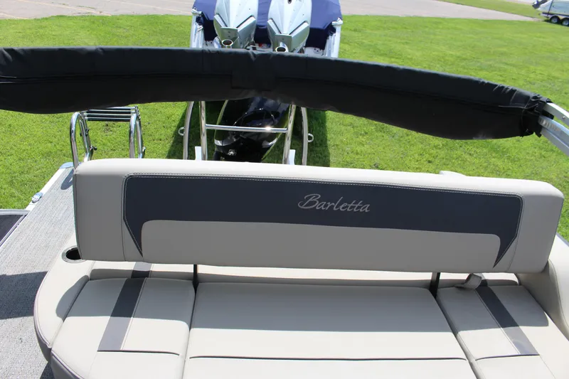 Slide: The Image of 2024 Barletta Aria 24UC boat interior with cushioned seating and sleek design. - 9