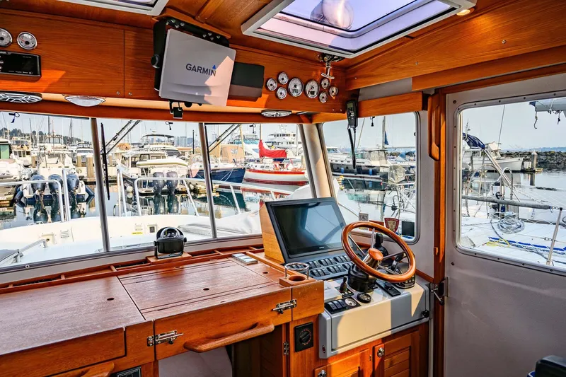 Slide: The Image of Interior of 2019 Targa 35 boat with wooden dashboard and marina view. - 11