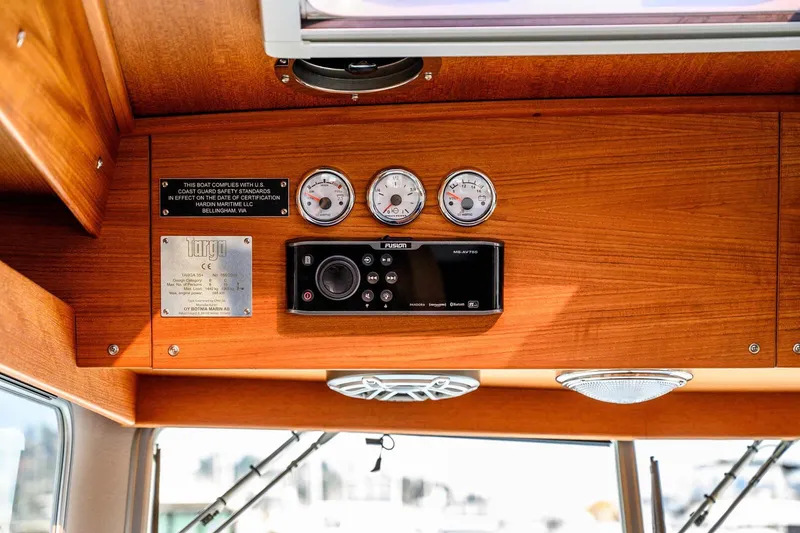 Slide: The Image of 2019 Targa 35 boat dashboard with gauges, control panel, and safety compliance plaque. - 12