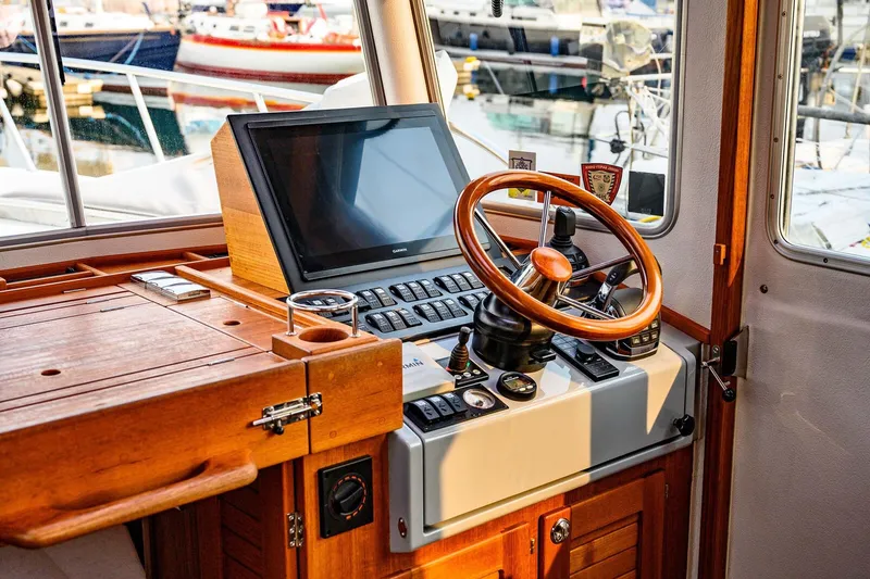 Slide: The Image of 2019 Targa 35 boat helm with wooden steering wheel and navigation equipment. - 14