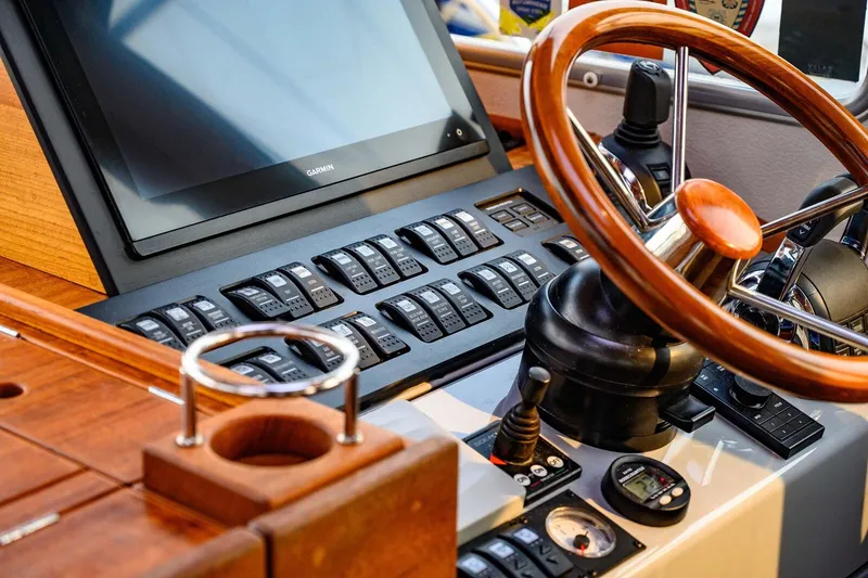 Slide: The Image of Control panel of a 2019 Targa 35 boat with wooden steering wheel and Garmin display. - 15
