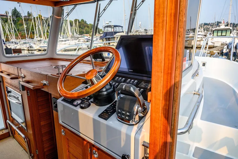 Slide: The Image of 2019 Targa 35 boat interior with wooden steering wheel and control panel at marina. - 16