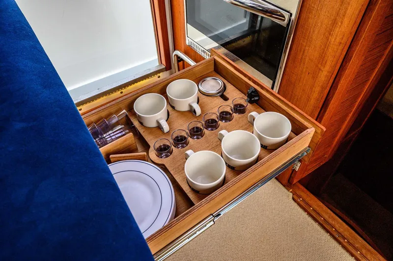 Slide: The Image of Wooden drawer with cups and glasses in a 2019 Targa 35 boat interior. - 19
