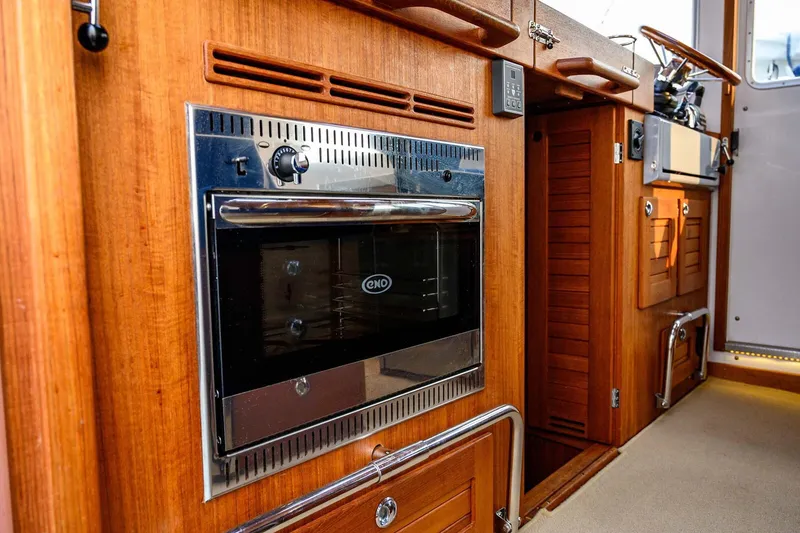 Slide: The Image of 2019 Targa 35 yacht interior with wooden cabinetry and built-in oven. - 20
