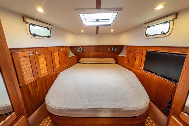 Slide: The Image of Cozy cabin interior of 2019 Targa 35 boat with wooden finish and comfortable bed. - 21