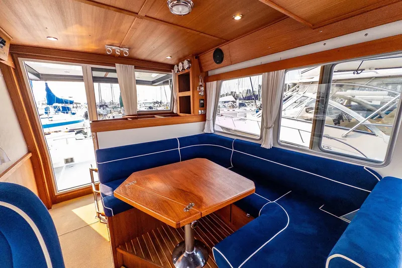 Slide: The Image of Interior of 2019 Targa 35 boat with blue seating and wooden table. - 25