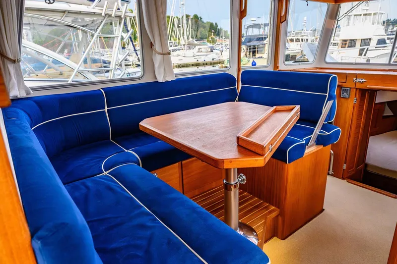 Slide: The Image of Interior of 2019 Targa 35 boat with blue seating and wooden table. - 26