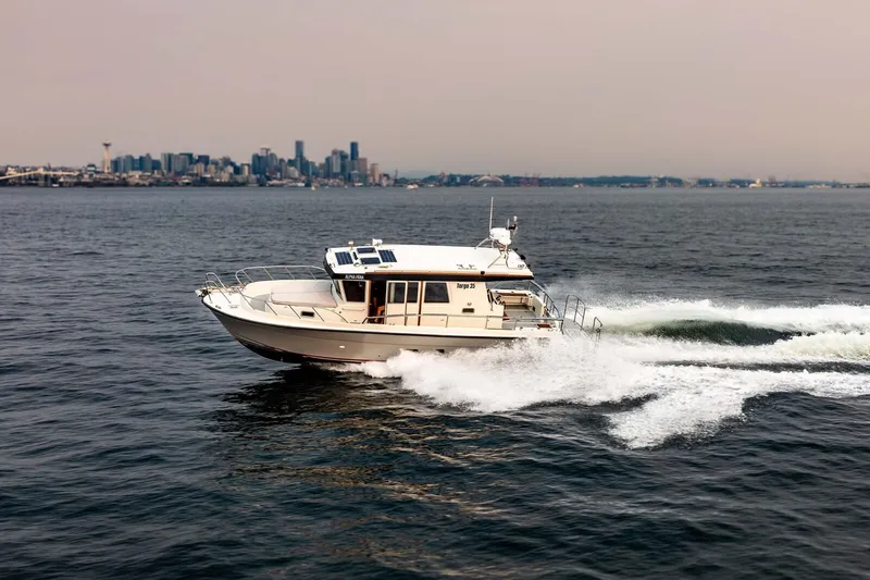 Slide: The Image of 2019 Targa 35 boat cruising on open water with city skyline in background. - 3