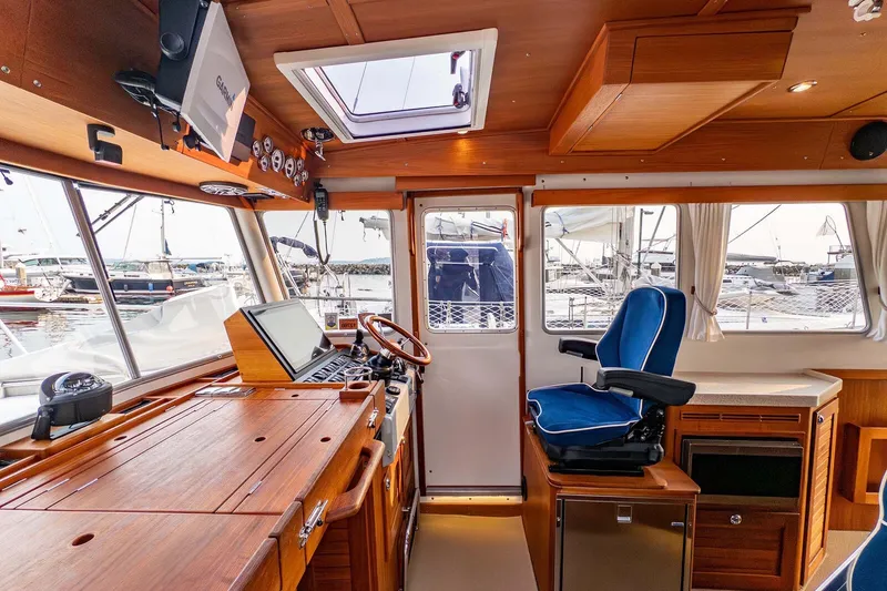 Slide: The Image of Interior of 2019 Targa 35 boat with wooden finish and blue captain's chair. - 32