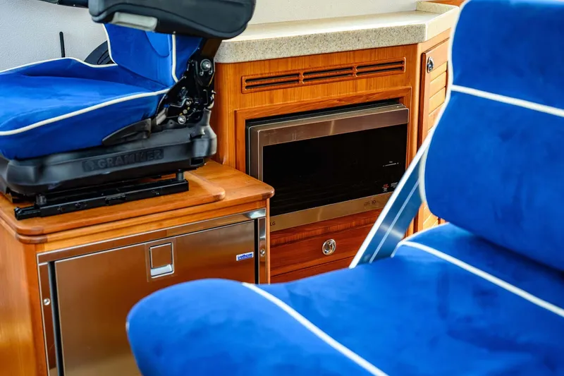 Slide: The Image of Interior of 2019 Targa 35 boat with blue seating and wooden cabinetry. - 33