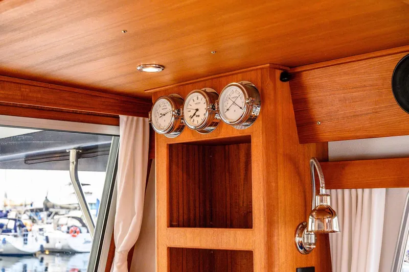 Slide: The Image of Interior of 2019 Targa 35 boat with wooden finish and nautical instruments. - 37