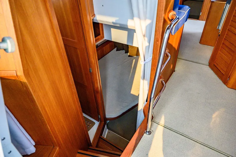 Slide: The Image of Interior of 2019 Targa 35 boat, featuring wooden finishes and a cozy cabin space. - 39