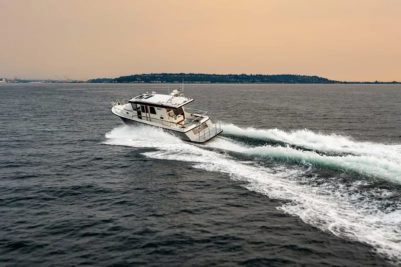 Slide: The Image of 2019 Targa 35 boat cruising on open water at sunset. - 4