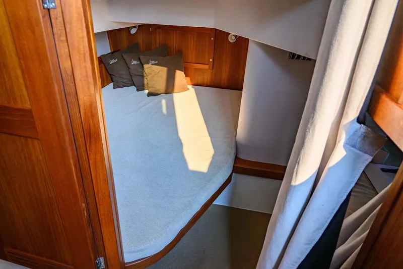 Slide: The Image of Cozy cabin interior of 2019 Targa 35 boat with wooden finish and cushions. - 41