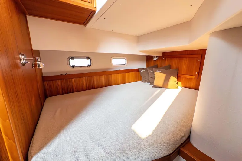Slide: The Image of Cozy cabin interior of 2019 Targa 35 boat with wooden accents and soft lighting. - 42