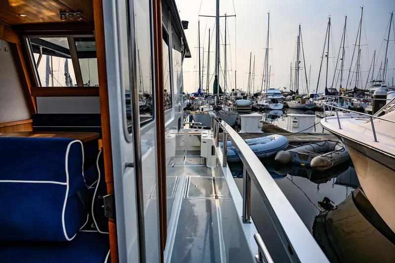 Slide: The Image of 2019 Targa 35 yacht docked in a marina, surrounded by sailboats. - 45