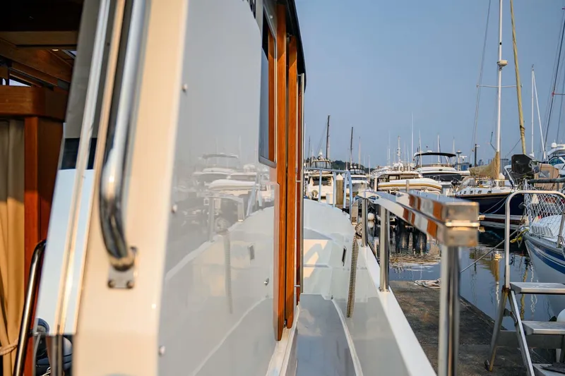 Slide: The Image of 2019 Targa 35 boat docked at marina, reflecting nearby vessels. - 48
