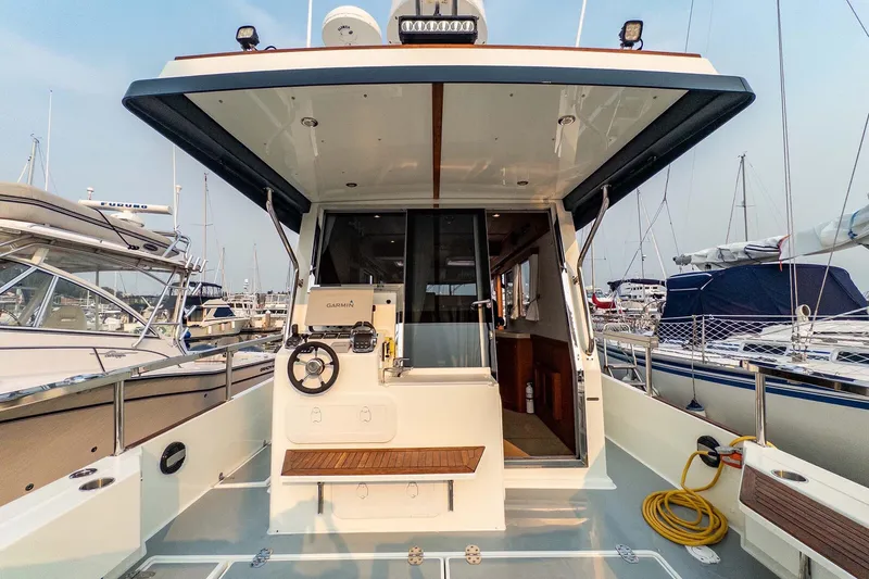 Slide: The Image of 2019 Targa 35 boat interior with helm, docked in marina. - 49