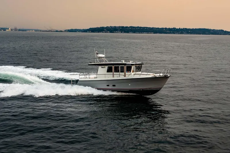 Slide: The Image of 2019 Targa 35 boat cruising on open water at sunset. - 5
