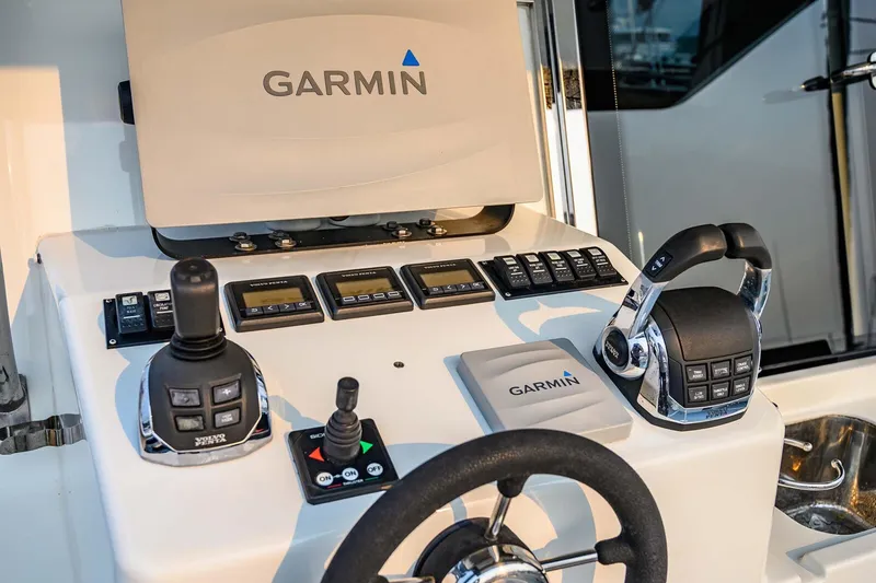 Slide: The Image of Control panel of a 2019 Targa 35 boat featuring Garmin navigation equipment. - 54